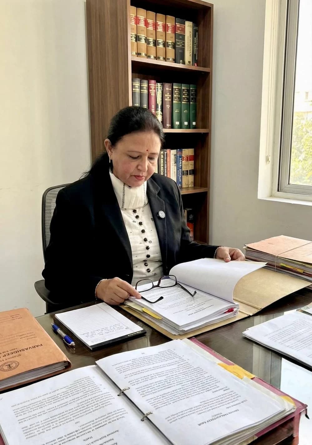 Advocate Parkashdeep Kaur reviewing case files in her chamber